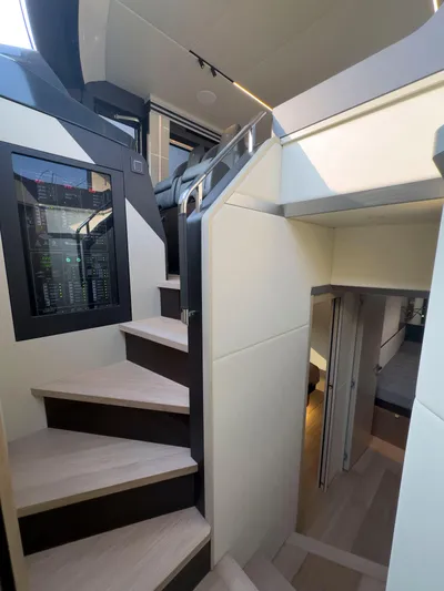  Yacht Photos Pics Interior staircase of 2022 Absolute 60 Fly yacht, featuring modern design and sleek finishes.