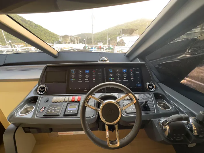  Yacht Photos Pics Helm of 2022 Absolute 60 Fly yacht with modern controls and scenic view.