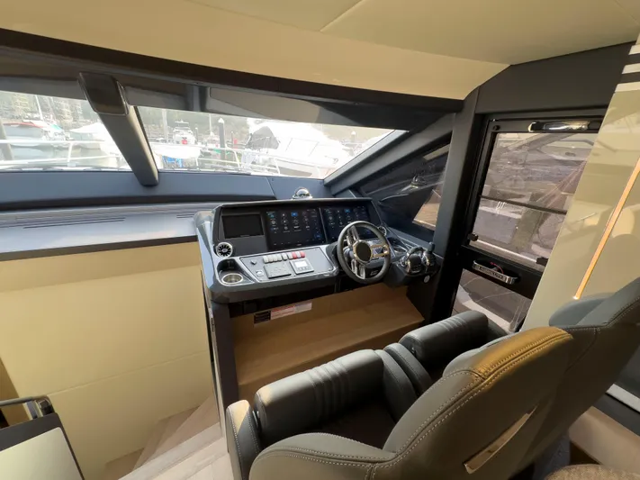  Yacht Photos Pics Cockpit of 2022 Absolute 60 Fly yacht with modern controls and steering wheel.