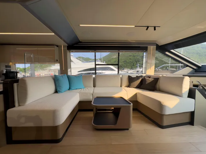  Yacht Photos Pics Luxurious interior of 2022 Absolute 60 Fly yacht with modern seating and scenic window views.
