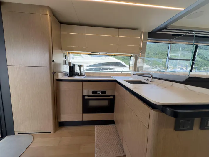  Yacht Photos Pics Modern kitchen interior on 2022 Absolute 60 Fly yacht, featuring sleek cabinetry and appliances.