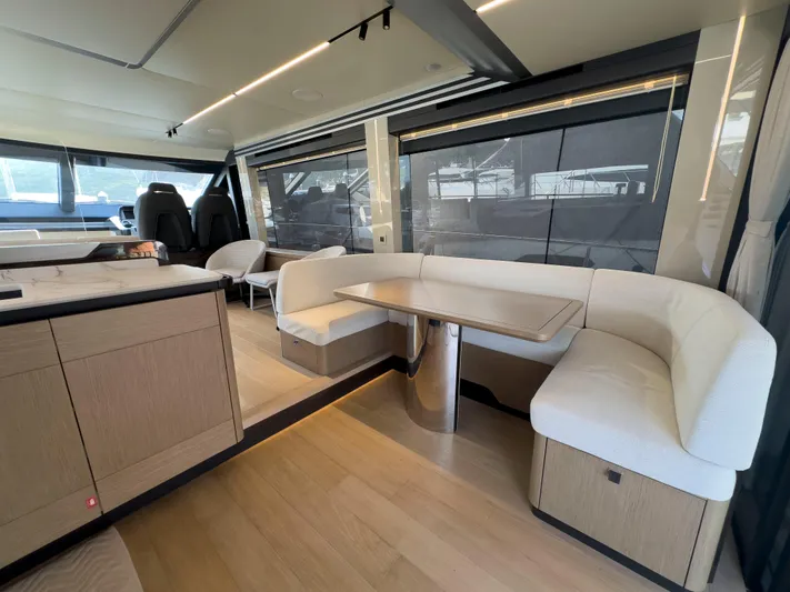  Yacht Photos Pics Luxurious interior of 2022 Absolute 60 Fly yacht with modern seating and dining area.