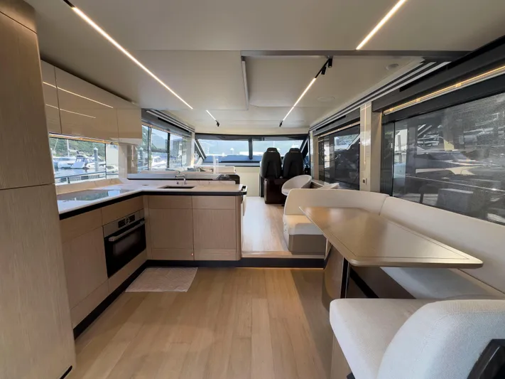  Yacht Photos Pics Luxurious interior of 2022 Absolute 60 Fly yacht with modern kitchen and seating area.
