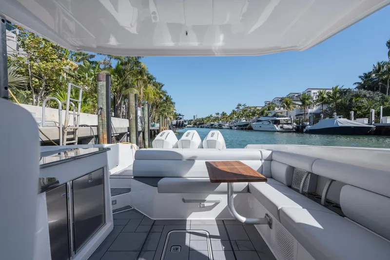 Pellicano Yacht Photos Pics 2023 Aviara AV36 OB luxury boat interior with sleek seating and scenic waterfront view.