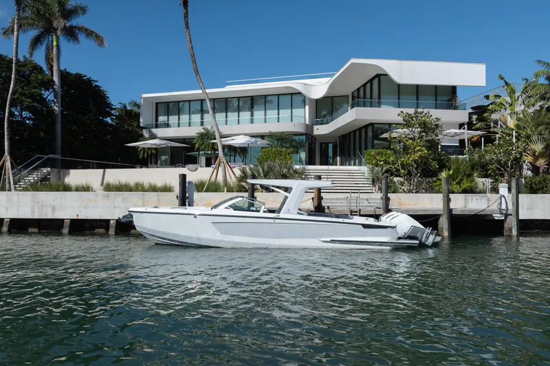 Pellicano Yacht Photos Pics 2023 Aviara AV36 OB boat docked by modern waterfront home.