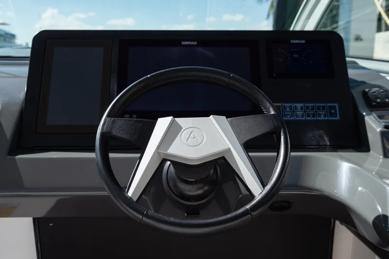 Pellicano Yacht Photos Pics Steering wheel of 2023 Aviara AV36 OB boat with modern dashboard display.