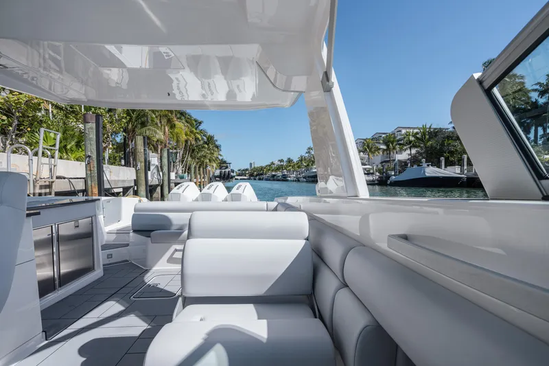 Pellicano Yacht Photos Pics 2023 Aviara AV36 OB luxury boat interior with sleek seating and scenic waterfront view.
