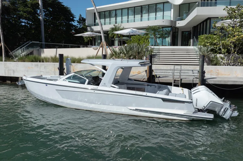 Pellicano Yacht Photos Pics 2023 Aviara AV36 OB boat docked by modern waterfront home.