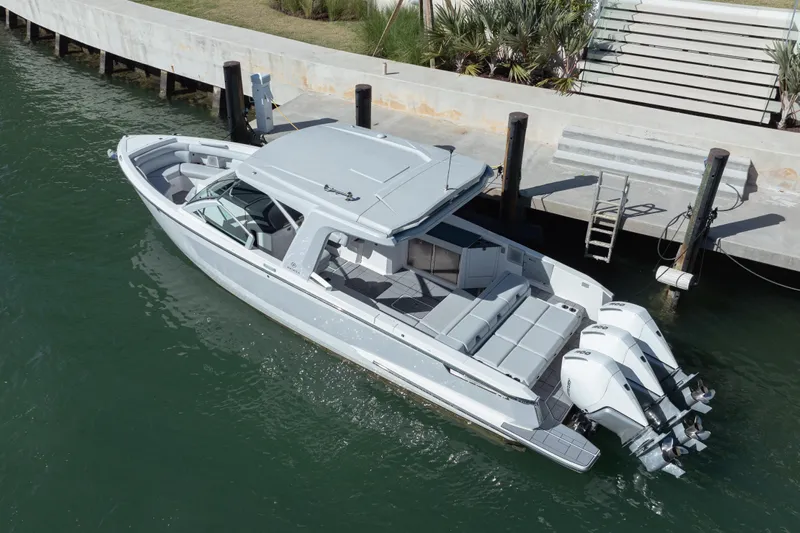 Pellicano Yacht Photos Pics 2023 Aviara AV36 OB boat docked in calm waters, showcasing sleek design and powerful engines.