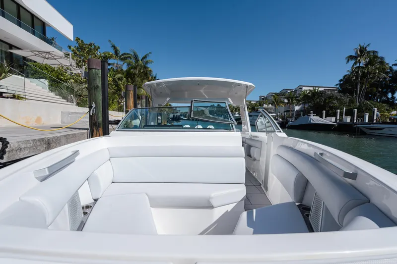 Pellicano Yacht Photos Pics 2023 Aviara AV36 OB luxury boat with spacious seating, docked by waterfront homes.
