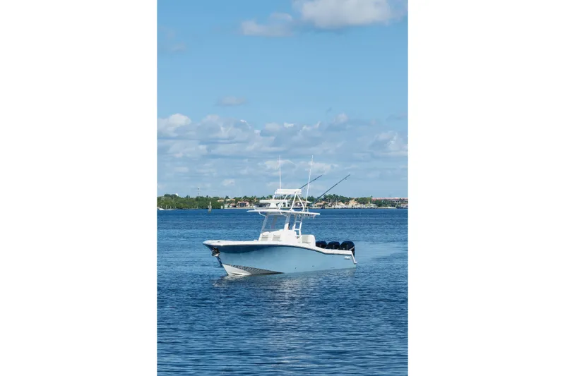  Yacht Photos Pics 2023 Invincible 36 Open Fisherman boat cruising on a calm blue sea.