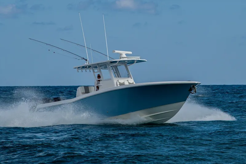  Yacht Photos Pics 2023 Invincible 36 Open Fisherman boat cruising on open ocean waters.