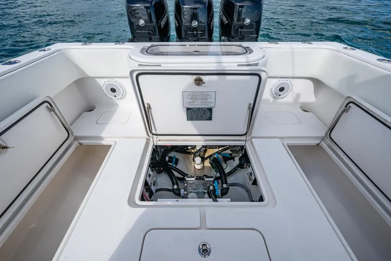  Yacht Photos Pics 2023 Invincible 36 Open Fisherman boat interior with open hatch and visible engine components.