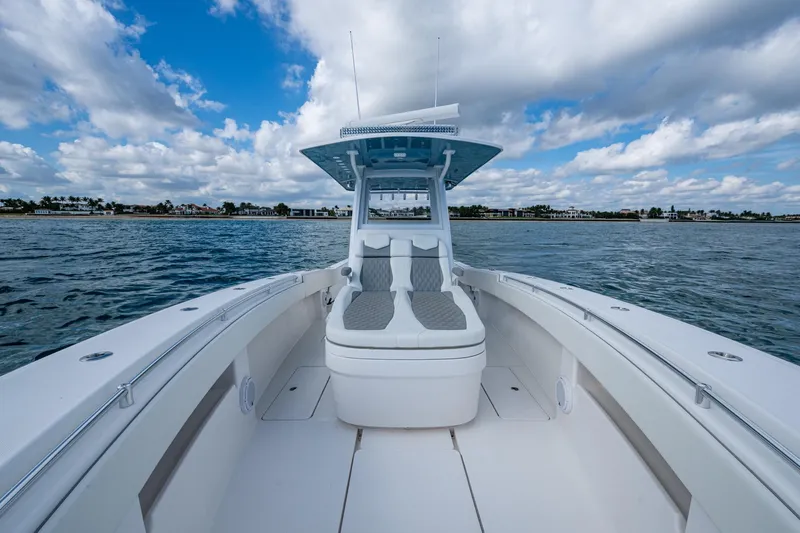  Yacht Photos Pics 2023 Invincible 36 Open Fisherman boat on calm waters under a cloudy sky.