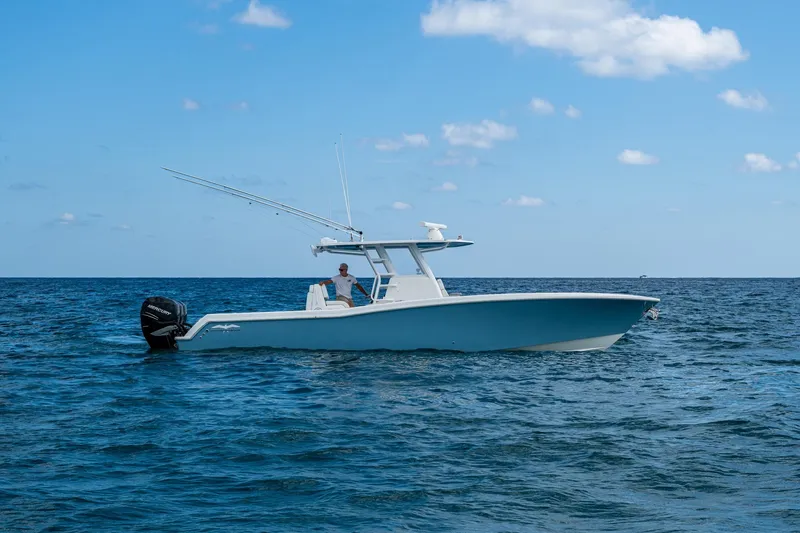  Yacht Photos Pics 2023 Invincible 36 Open Fisherman boat on open sea under blue sky.