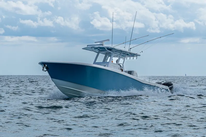  Yacht Photos Pics 2023 Invincible 36 Open Fisherman boat cruising on open water under cloudy sky.