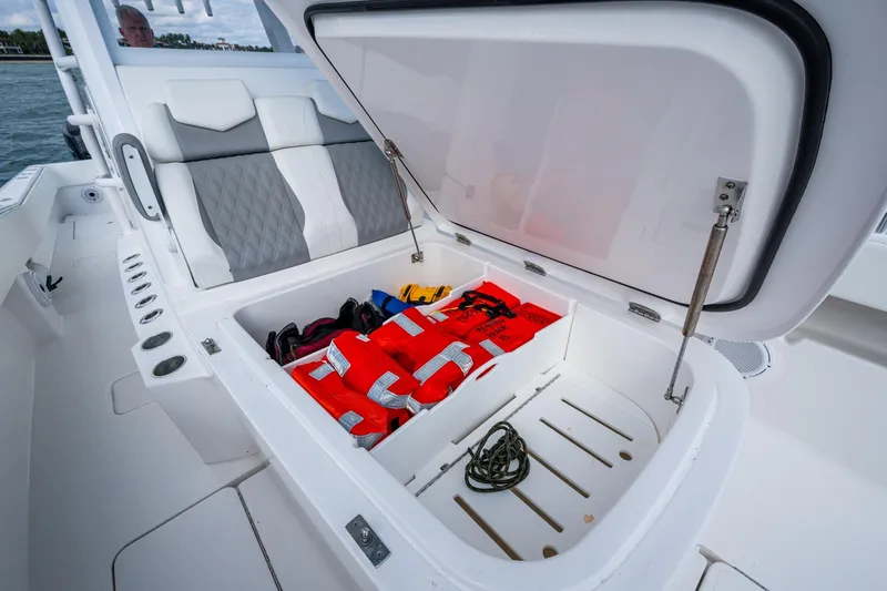  Yacht Photos Pics 2023 Invincible 36 Open Fisherman boat storage with life jackets and rope.