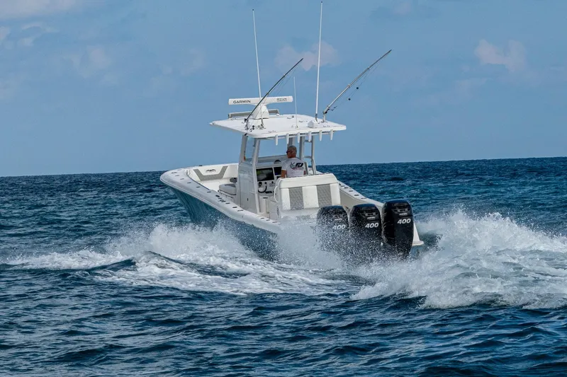  Yacht Photos Pics 2023 Invincible 36 Open Fisherman boat cruising on ocean waves.