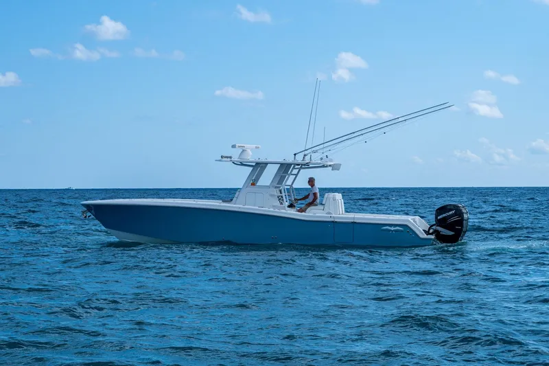  Yacht Photos Pics 2023 Invincible 36 Open Fisherman boat cruising on open ocean waters.