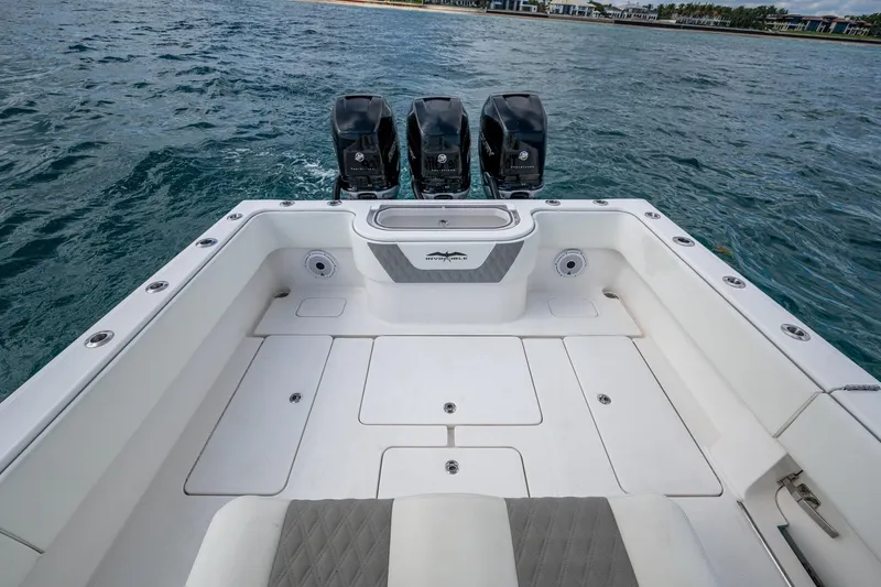  Yacht Photos Pics 2023 Invincible 36 Open Fisherman boat with triple outboard engines on the ocean.