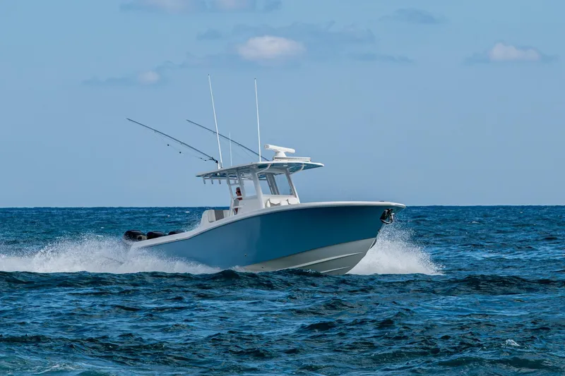  Yacht Photos Pics 2023 Invincible 36 Open Fisherman boat cruising on open ocean waters.
