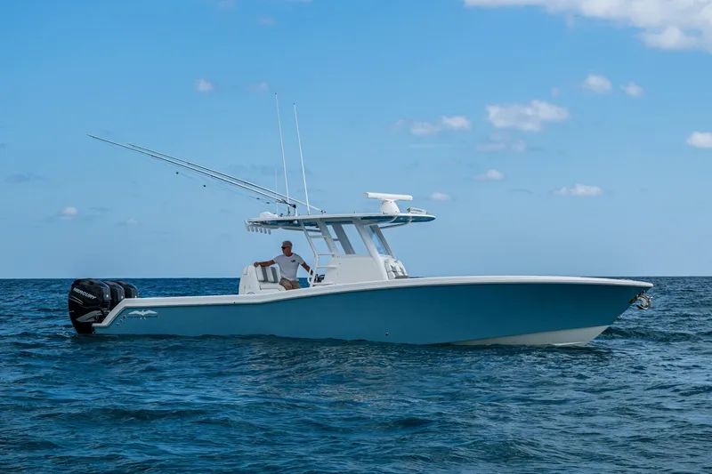  Yacht Photos Pics 2023 Invincible 36 Open Fisherman boat on open water under clear blue sky.