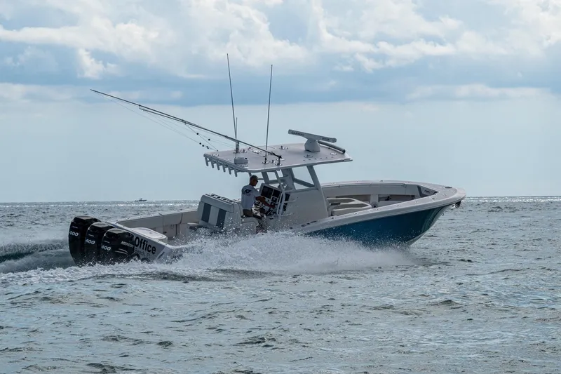  Yacht Photos Pics 2023 Invincible 36 Open Fisherman cruising on the ocean with triple outboard engines.