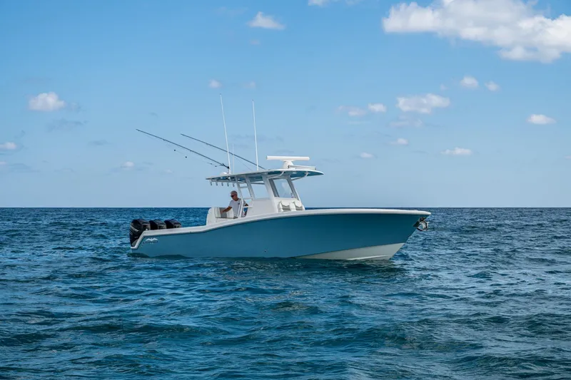  Yacht Photos Pics 2023 Invincible 36 Open Fisherman boat on open sea under blue sky.