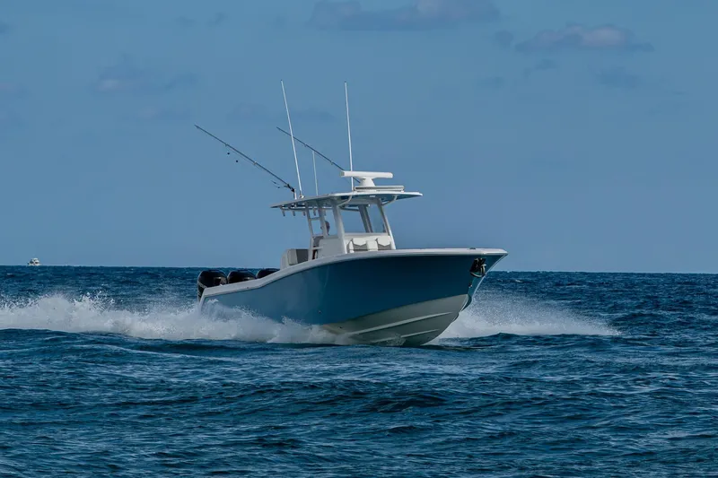  Yacht Photos Pics 2023 Invincible 36 Open Fisherman boat cruising on open ocean waters.