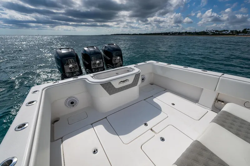  Yacht Photos Pics 2023 Invincible 36 Open Fisherman boat with triple outboard engines on open water.