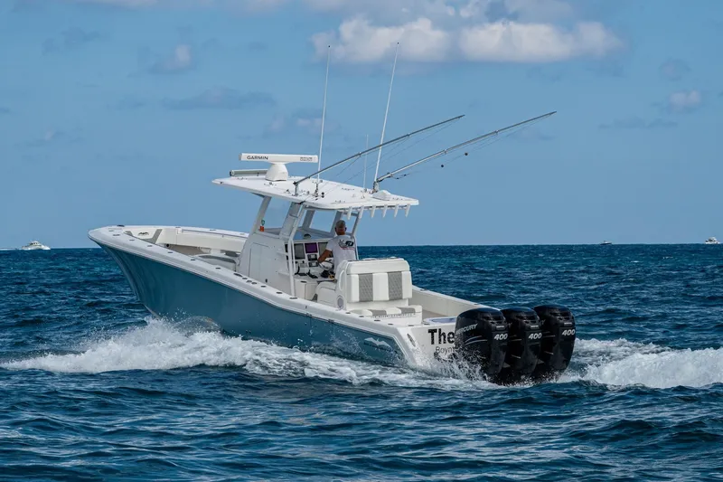  Yacht Photos Pics 2023 Invincible 36 Open Fisherman boat cruising on open water with triple engines.