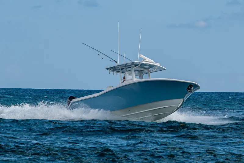  Yacht Photos Pics 2023 Invincible 36 Open Fisherman boat cruising on open ocean waters.