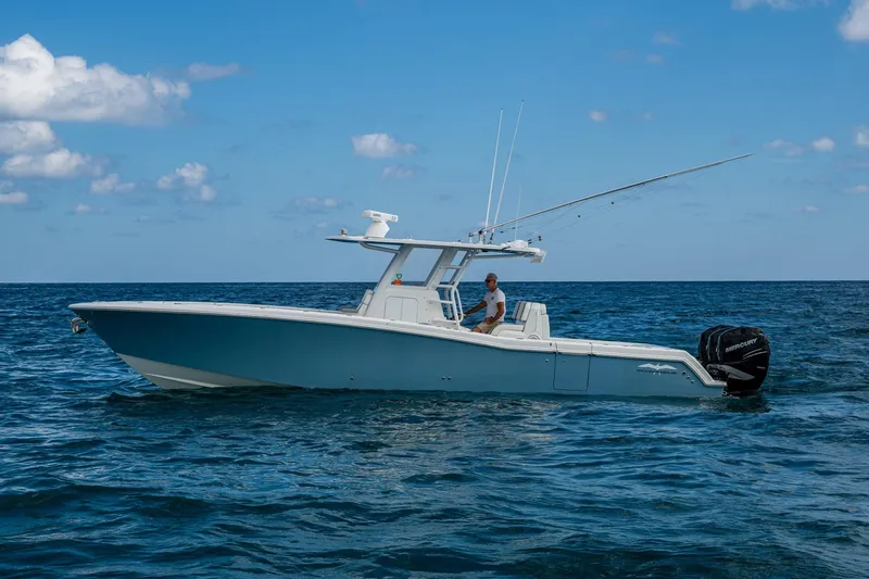  Yacht Photos Pics 2023 Invincible 36 Open Fisherman boat on open sea under blue sky.