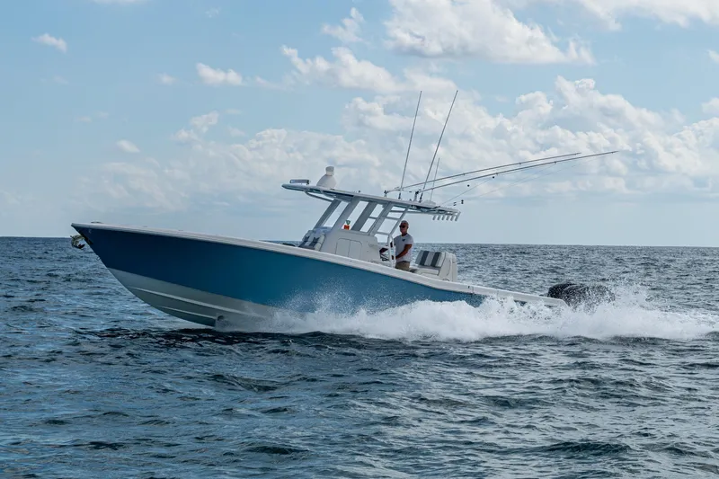  Yacht Photos Pics 2023 Invincible 36 Open Fisherman boat cruising on open water under a cloudy sky.