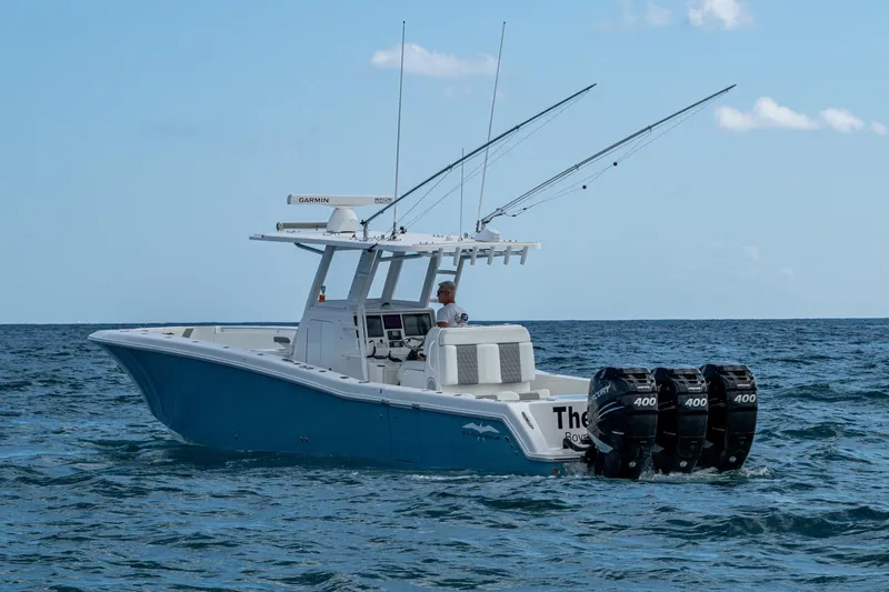  Yacht Photos Pics 2023 Invincible 36 Open Fisherman boat with triple Mercury engines on the ocean.