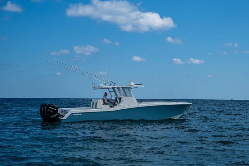  Yacht Photos Pics 2023 Invincible 36 Open Fisherman boat on open sea under blue sky.
