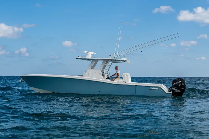  Yacht Photos Pics 2023 Invincible 36 Open Fisherman boat on open sea under blue sky.