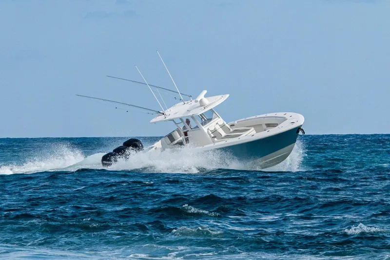  Yacht Photos Pics 2023 Invincible 36 Open Fisherman navigating ocean waves.