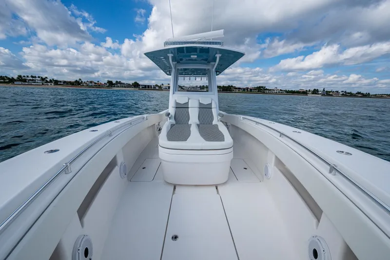  Yacht Photos Pics 2023 Invincible 36 Open Fisherman boat on calm waters under a cloudy sky.