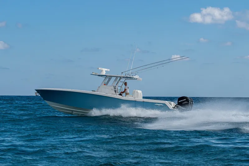  Yacht Photos Pics 2023 Invincible 36 Open Fisherman boat cruising on open water.