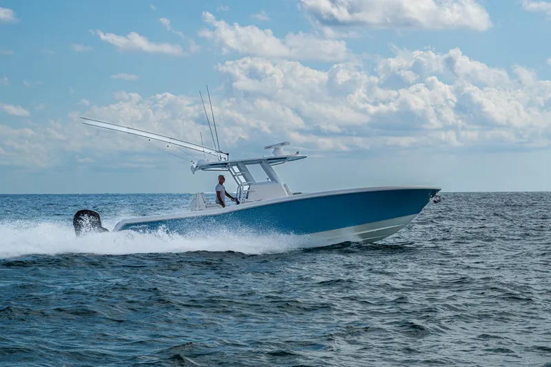  Yacht Photos Pics 2023 Invincible 36 Open Fisherman cruising on open water under a cloudy sky.
