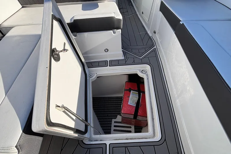  Yacht Photos Pics 2023 Monterey 385SS Super Sport boat storage compartment with red item inside.