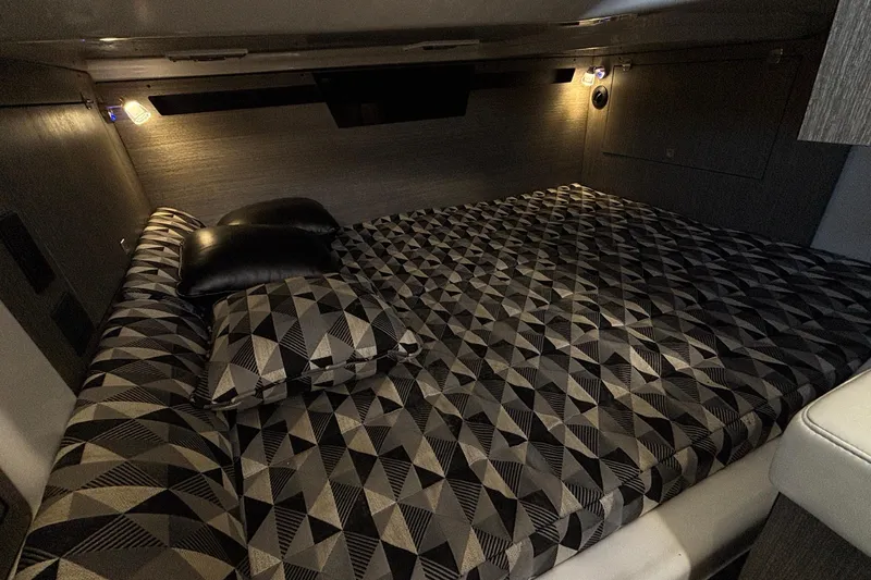  Yacht Photos Pics Luxurious cabin interior of 2023 Monterey 385SS Super Sport with geometric-patterned bedding.