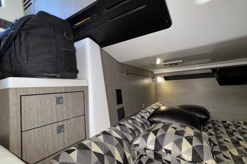  Yacht Photos Pics 2023 Monterey 385SS Super Sport cabin interior with geometric-patterned cushions and storage.