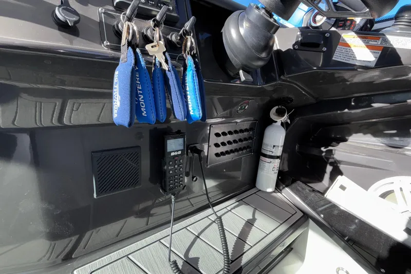  Yacht Photos Pics 2023 Monterey 385SS Super Sport dashboard with keys, radio, and fire extinguisher.