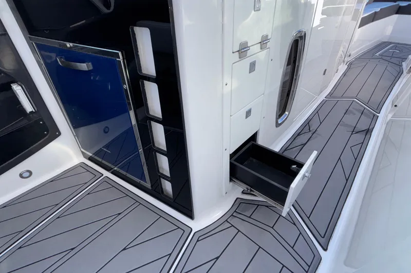  Yacht Photos Pics 2023 Monterey 385SS Super Sport boat interior with open storage drawer and sleek flooring.