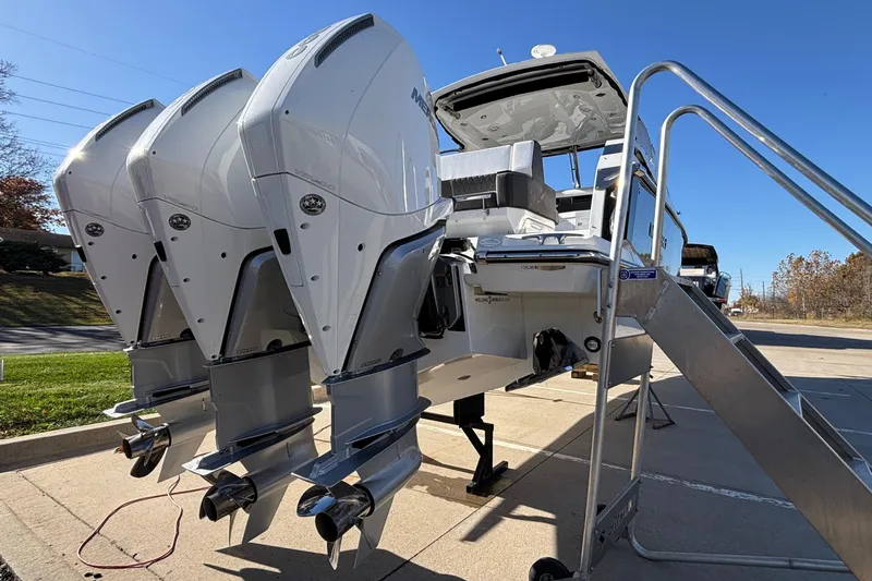  Yacht Photos Pics 2023 Monterey 385SS Super Sport boat with triple outboard engines on display.