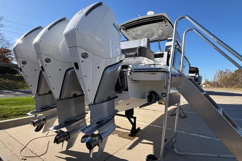  Yacht Photos Pics 2023 Monterey 385SS Super Sport boat with triple outboard engines on display.