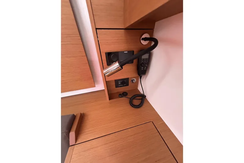  Yacht Photos Pics 2024 Beneteau First 44 yacht interior with modern control panel and wooden finish.