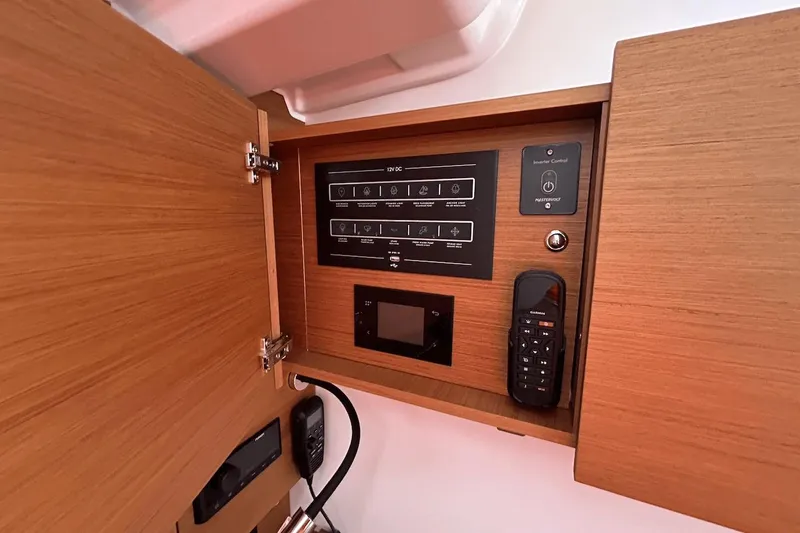  Yacht Photos Pics Control panel inside 2024 Beneteau First 44 yacht, featuring modern navigation and communication equipment.